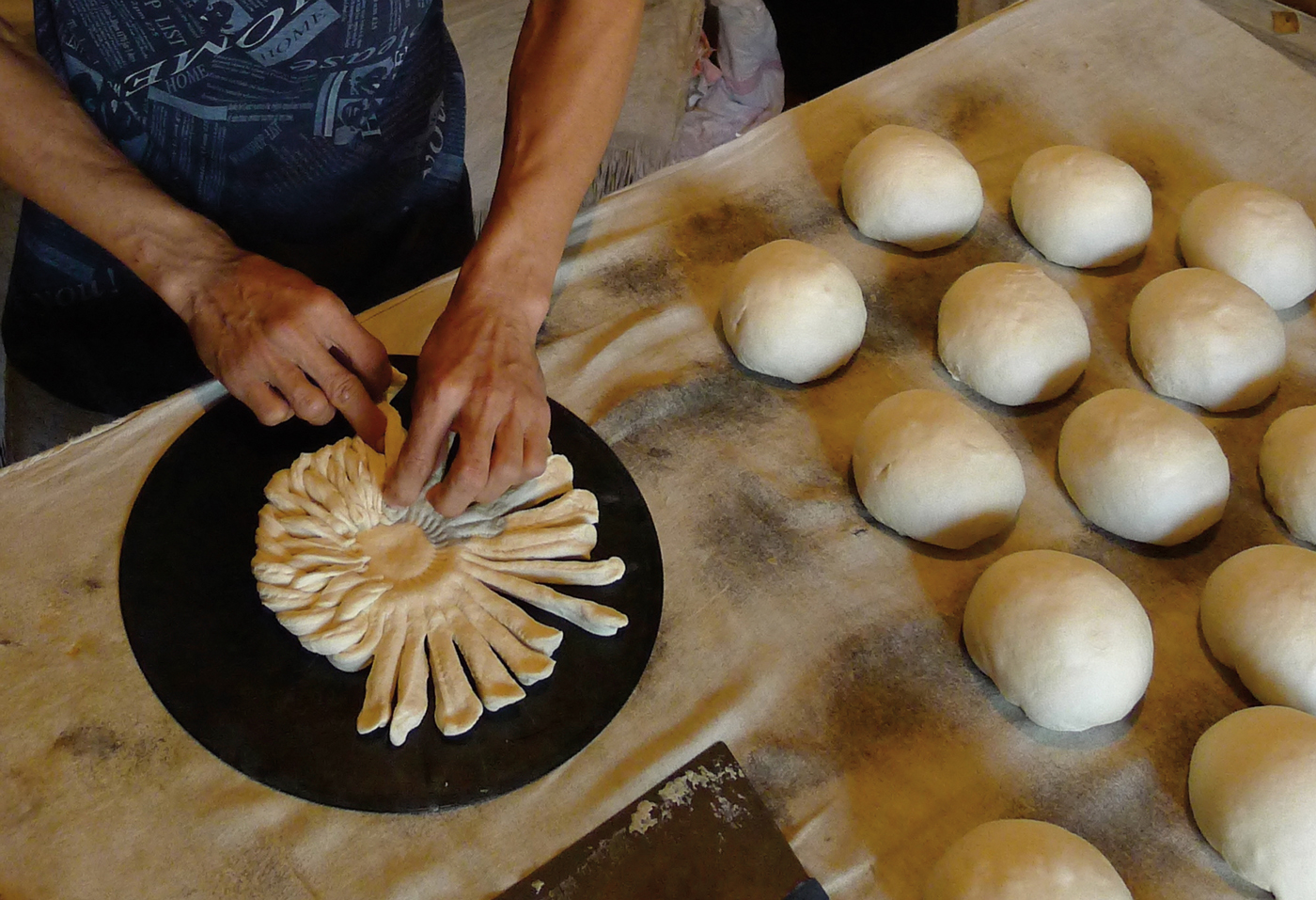 Raushanbek Ismailov is a&nbsp;<em>nonvoy</em>&mdash;a bread baker; here, he braids a decorative, Tashkent-style non.