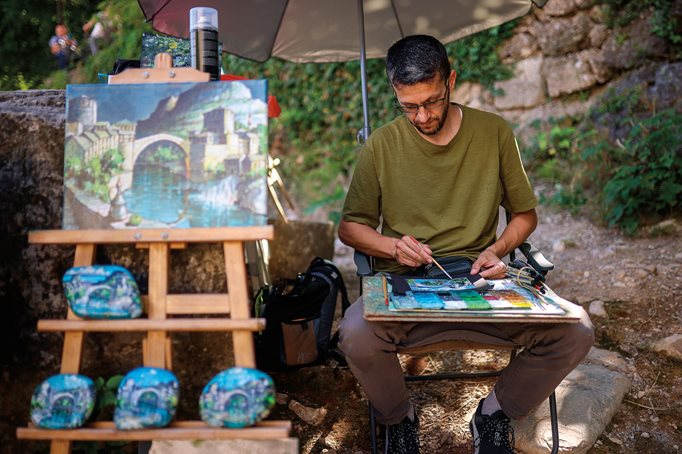Edin “Dino” Šipković works on a painting of the Old Bridge in the old part of Mostar. 