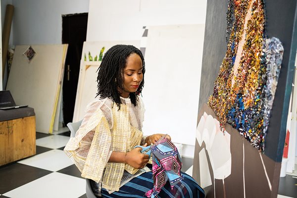 The artist makes collages of densely packed fabric pieces to create images of daily life.
