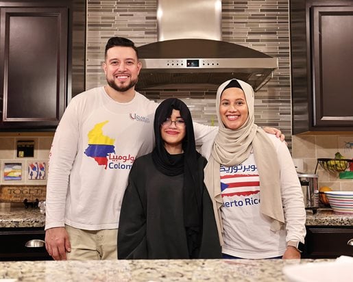 Alex and Eveliz Gutierrez, joined by their daughter, show off their homeland pride via their bilingual IslamInSpanish shirts.