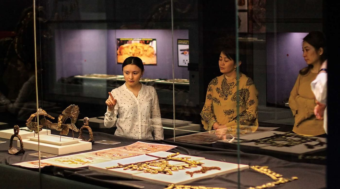 Visitors to the National Museum of Kazakhstan in Nur-Sultan examine a horse saddle and pair of stirrups discovered in southwest- ern Kazakhstan and restored by Altynbekov and his team, who have helped Kazakhstan distinguish its culture from both its Turkic and Soviet neighbors.