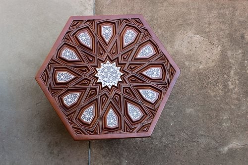 Among the Design Hub’s inaugural collection were, top, “Muzhir Tea Box,” by Nesreen Sharara, who used materials and a pattern inspired by the minbar of Abu Bakr Mazhar (see opposite, lower). “Lajin Tray,” above, by Hana al-Masry, uses a star and arabesque from the minbar of Sultan Lajin. right Tuhfajji (traditional carpenter) Sabry Saber made “Mu’ayyad Table” with a 12-point design found along the balustrade of the minbar of Sultan al-Mu’ayyad Shaykh.