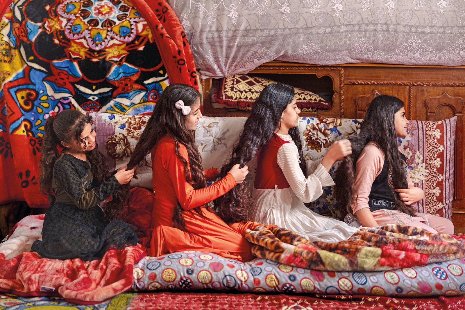 In the morning, four sisters woke me with tea, fried eggs and bread, and they turned on the faucet to fill a basin. We took turns washing, and then the sisters joined up in a line to comb and plait one another’s hair. It was a gentle moment, the kind I like to share and that replenishes me on a journey. My own hair was being plaited as I took this photo.