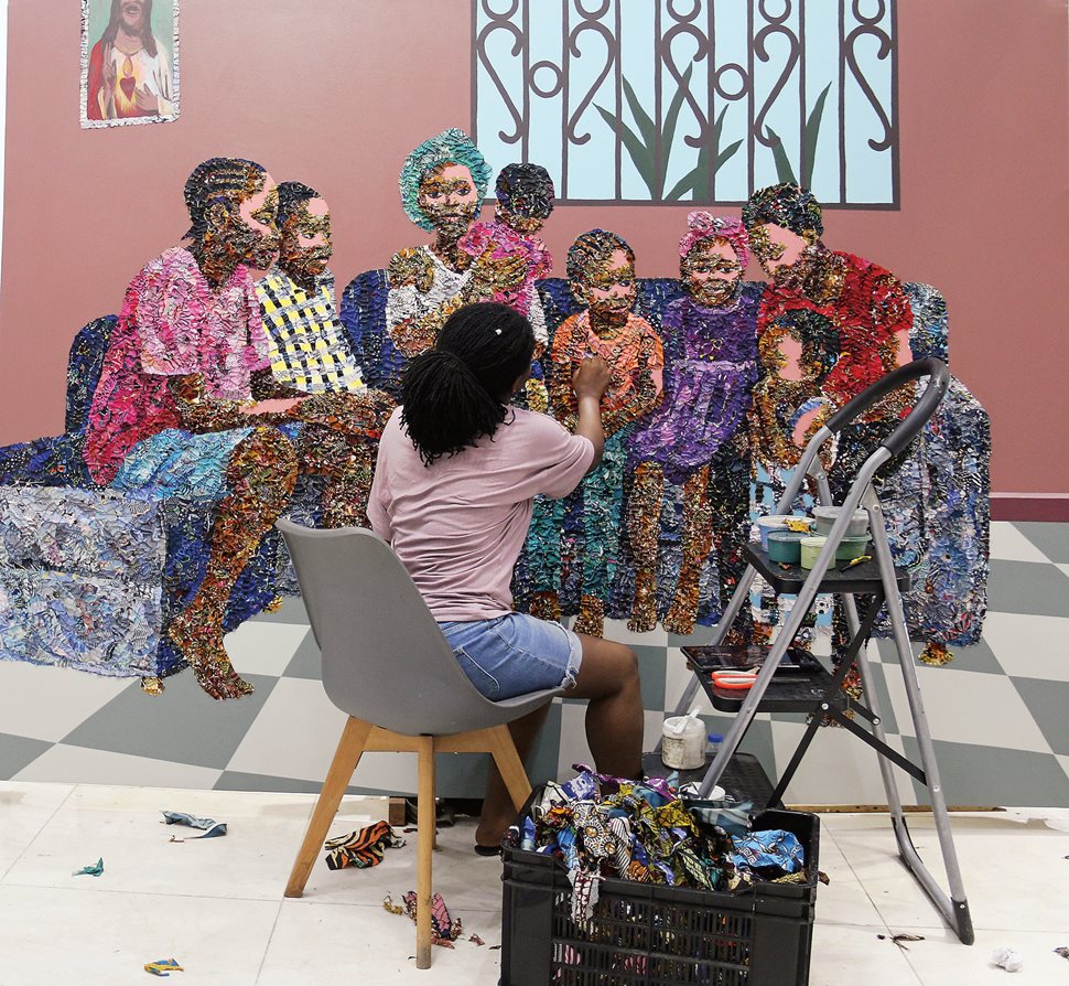 Marcellina Akpojotor works on a large canvas earlier this year.