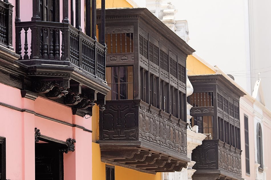 Across the street from and stylistically reflecting the Palace of Torre Tagle, Goyeneche House, built in 1771, also flanks a baroque stone entrance with mudéjar balconies. Although they have been remodeled with glass, they maintain traditional proportions and structures of the mashrabiya balconies of the Arab world and al-Andalus: waist-high, solid walls topped with two layers of wrap-around windows, cantilevered over the streets on strong timbers. 