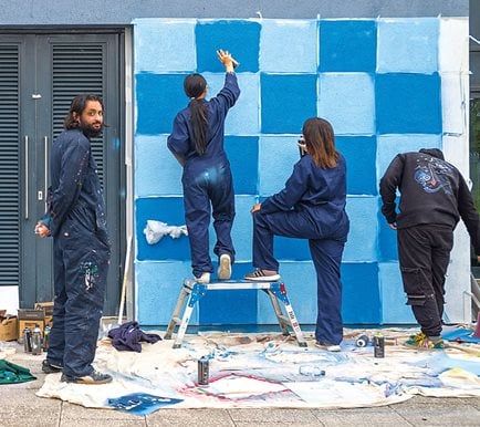Teakster, at left, leads a mural at the Aylesbury Vale Blueprint School. “Murals offer accessibility to art without barriers associated with education or finance,” he says.